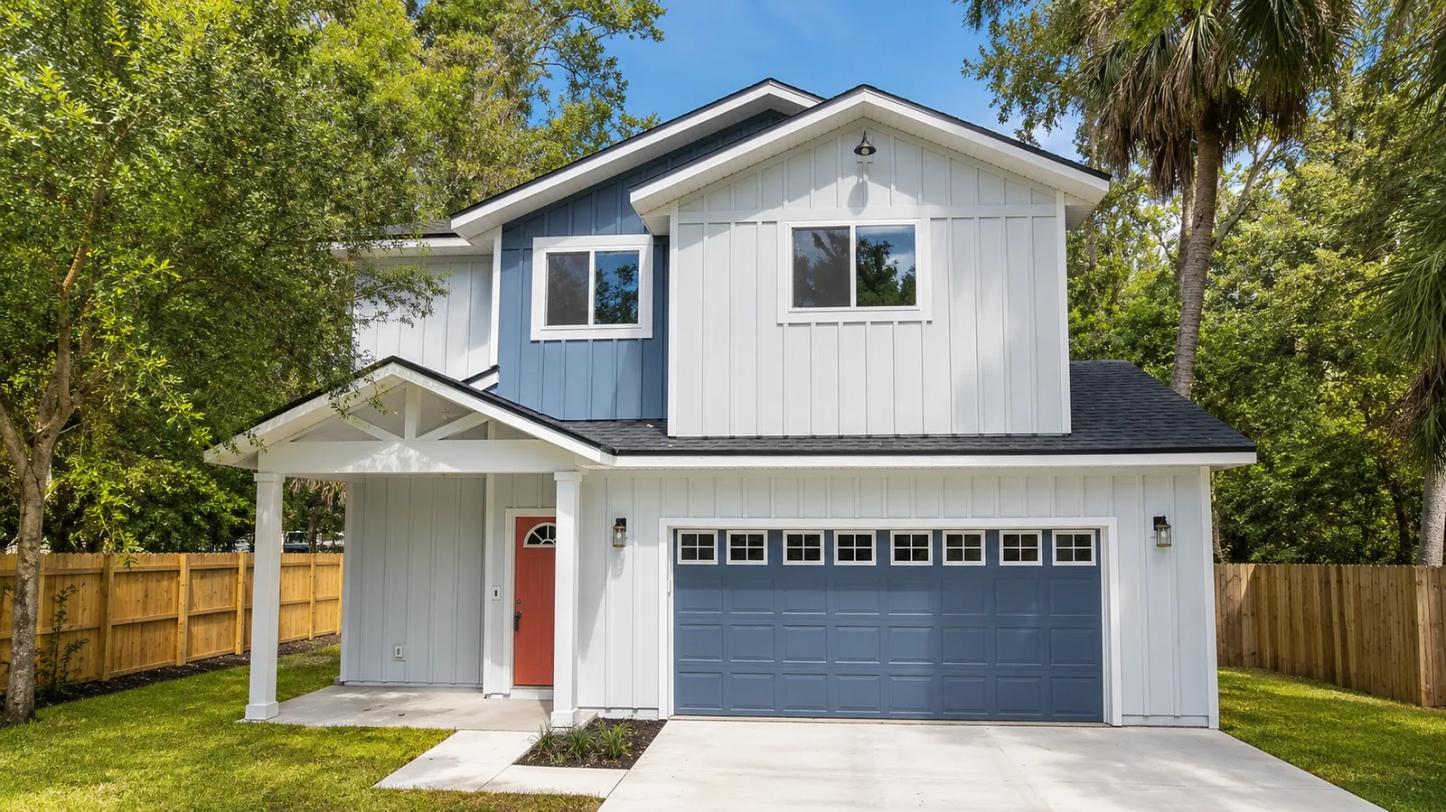 Two-story coastal home with blue garage door, new construction